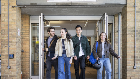 four students leaving the faculty of music through the double doors
